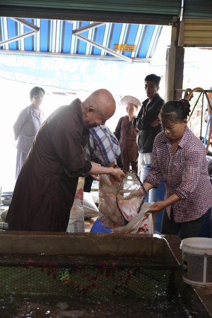 Praying for rebirth and releasing creatures in Ba Lua port, Cu Chi